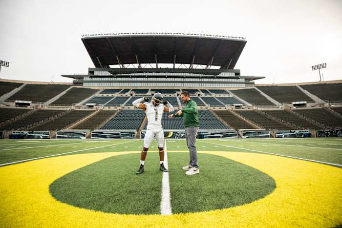 Aaron Flowers poses with Dan Lanning inside Autzen Stadium.
